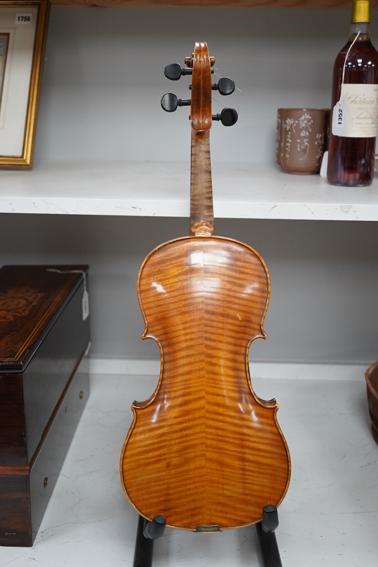 A late 19th century German violin in a Hill & Son oak case, with Hill canvas slip cover, together with an unbranded silver mounted bow, and another, ivory submission ref: 9HJU3B45 and ZC2E1GCP